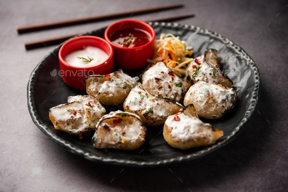 Tandoori momo, veg or non veg in red and cream sauce, served with sauce.  Nepal and Tibet recipe